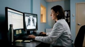 Radiologist examining X-ray scans in reading room